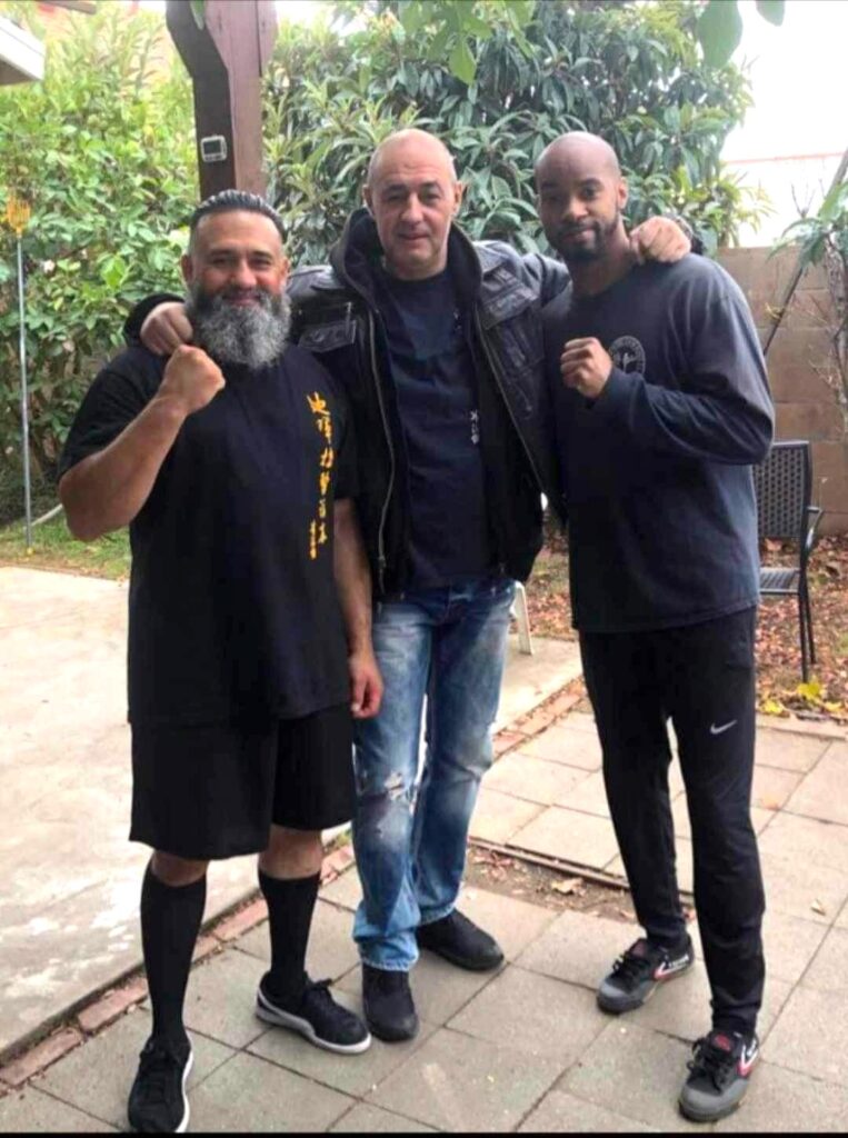 Guadalupe in the middle with 2 other athletes posing with their fist.